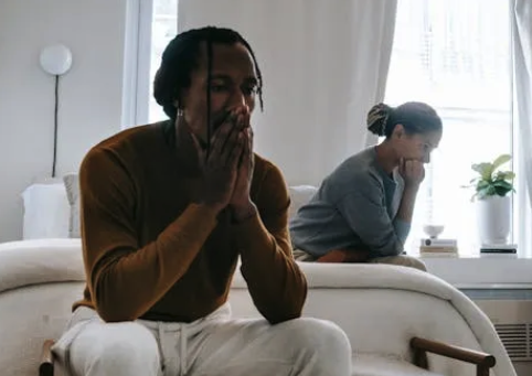 a man and woman sitting on a couch in a living room