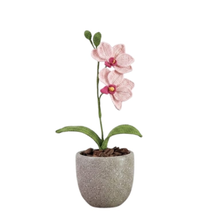 Handmade crochet pink orchid plant with green leaves in a grey concrete pot, perfect for home decor and gifts.