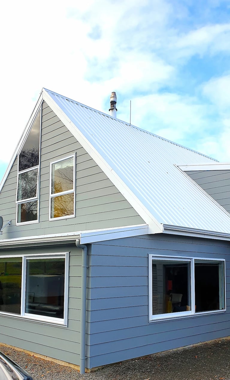 Freshly painted A‑frame home with crisp detailing, completed by Gee Cee Painter’s Glen Currie for a renewed, lasting finish