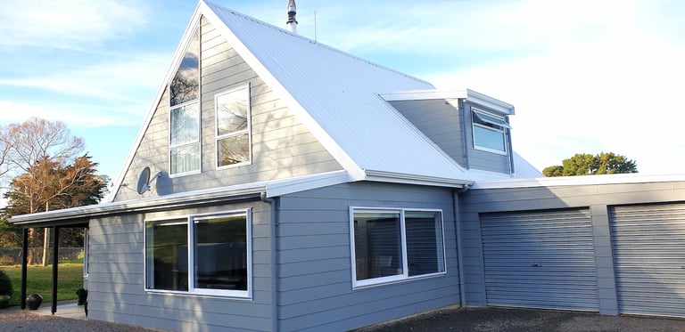 Freshly painted modern A‑frame home with crisp detailing, completed by Gee Cee Painter’s for a renewed, lasting finish