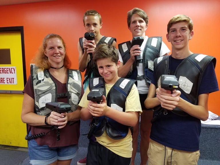 family posing for laser tag