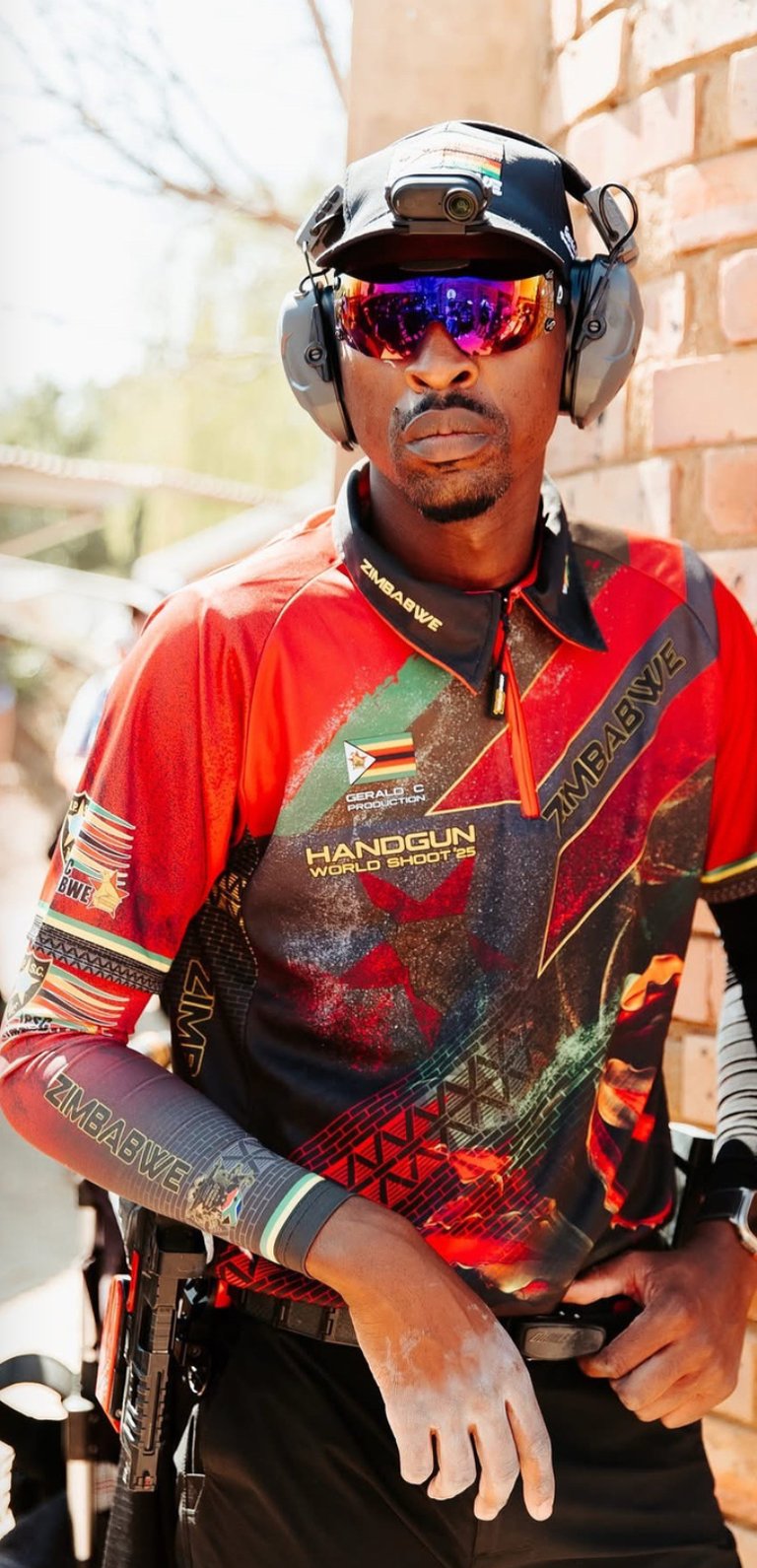 Gerald Chari at Handgun World Shoot wearing tactical gear and protective eyewear.