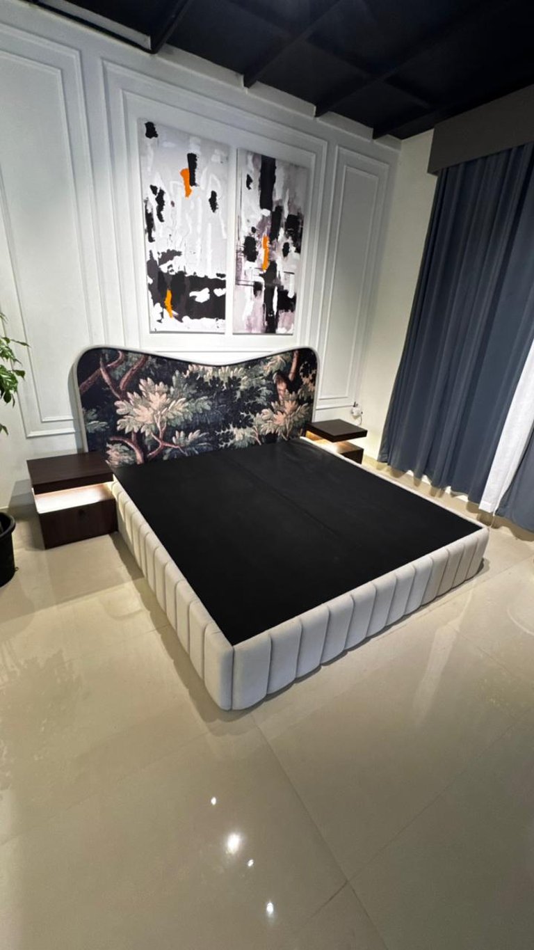 Modern luxury bed with floral tapestry headboard and integrated floating nightstands in a bedroom.