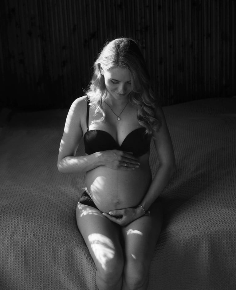 pregnant woman hugging her belly