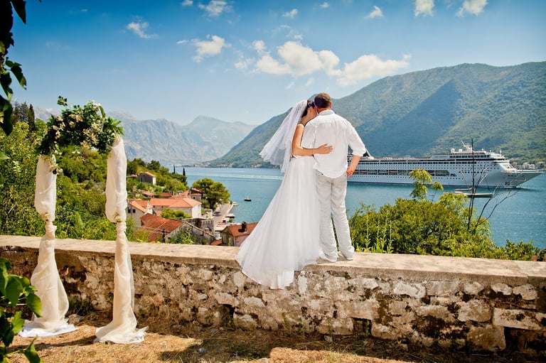 Wedding couple photo of Boka bay ceremony with wedding arch and cruise liner ship
