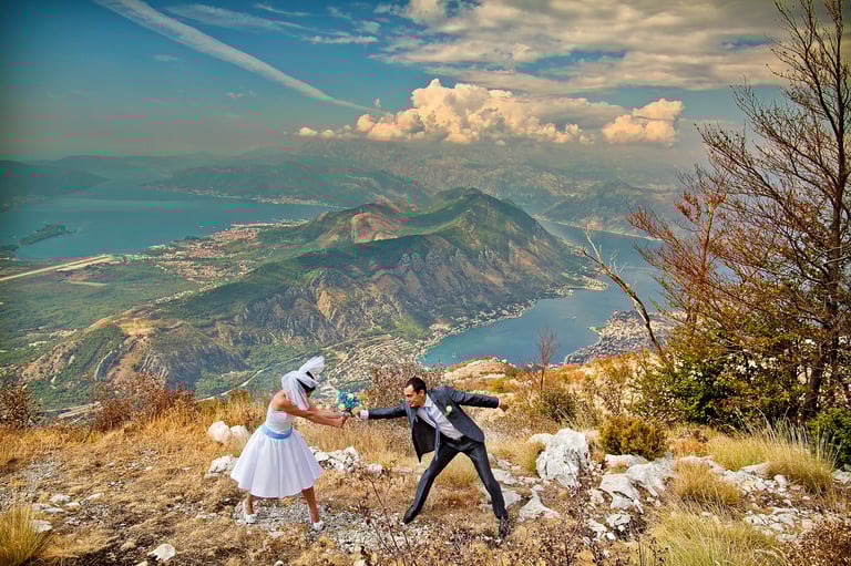 Wedding couple with wedding flowers over the Boka Bay above Kotor
