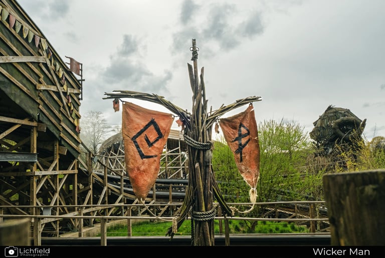 A wicker pole with  orange flags on it at Wicker Man Alton towers