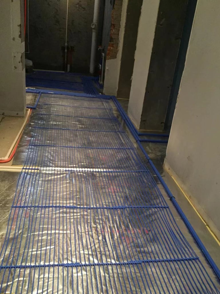 Hydronic radiant floor heating installation with capillary tube mats over reflective insulation.