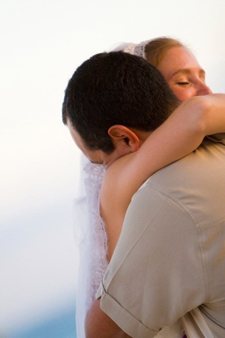 Beach Destination Wedding. Bride and Groom Hugging. Eyes closed. San Jose del Cabo, Mexico.