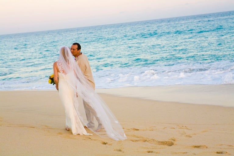 Beach Destination Wedding. Bride and Groom Photo Shoot. Walking and kissing on the beach. San Jose del Cabo, Mexico.