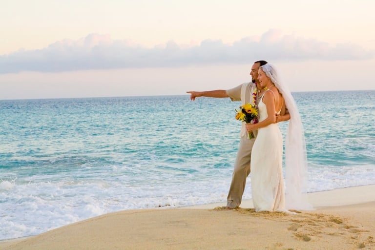 Beach Destination Wedding. Bride and Groom Photo Shoot. Pointing and smiling on the beach. San Jose del Cabo, Mexico.