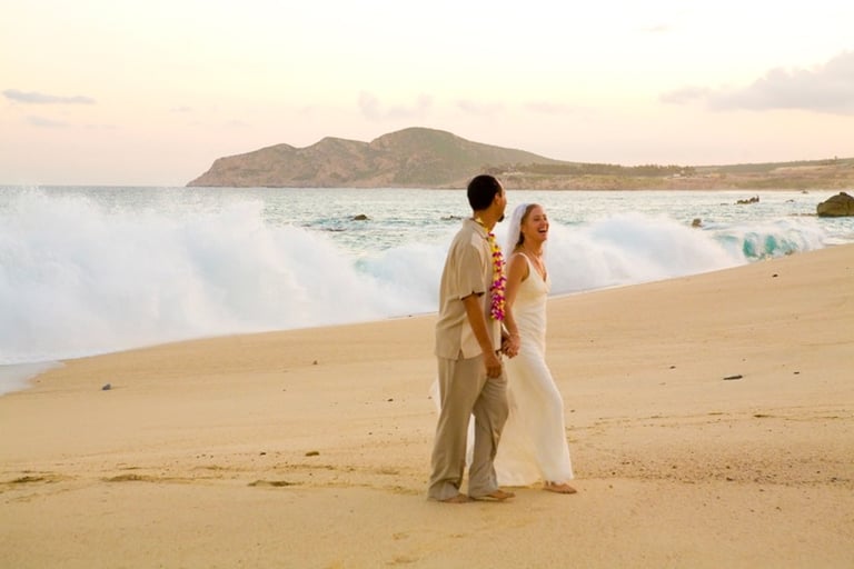 Beach Destination Wedding. Bride and Groom Photo Shoot. Walking and smiling. Waves crashing. San Jose del Cabo, Mexico.