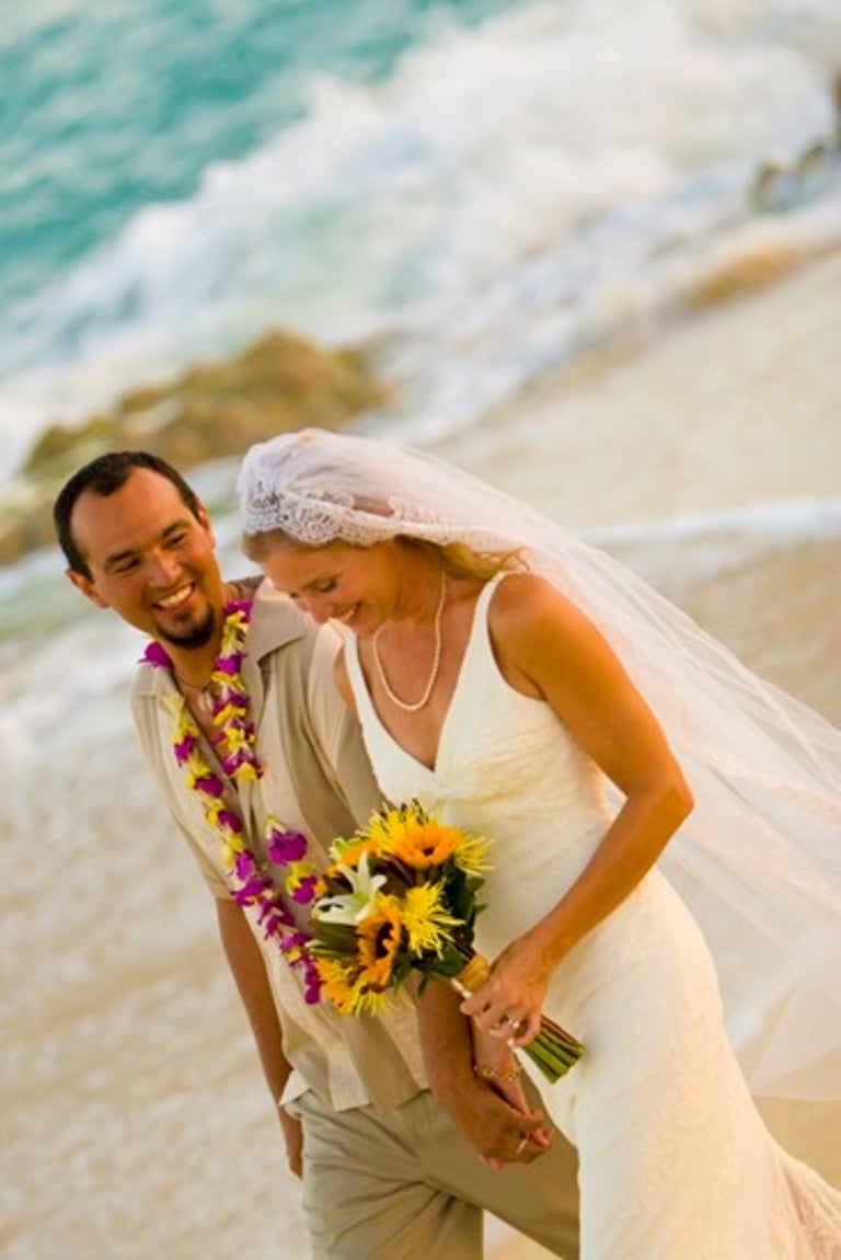 Beach Destination Wedding. Bride and Groom Photo Shoot. Smiling and walking on the beach. San Jose del Cabo, Mexico.