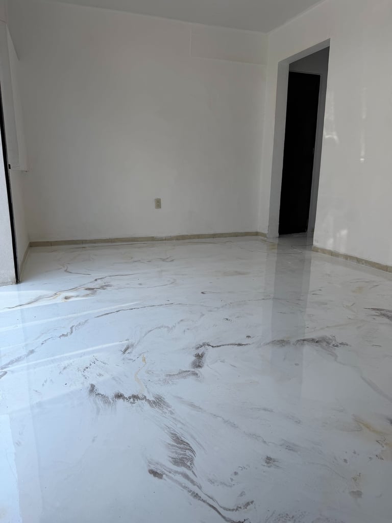 Modern interior featuring a glossy white marble-effect epoxy resin floor in an empty room.