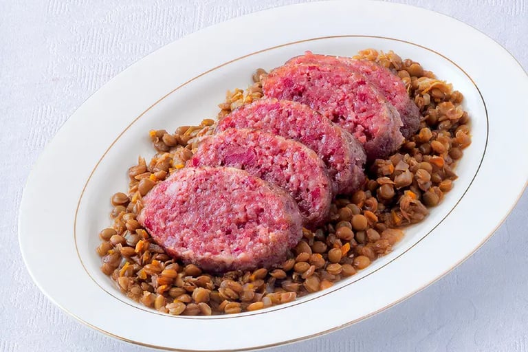 Italian lentils served with cotechino sausage, a traditional New Year’s Eve dish symbolizing prosperity
