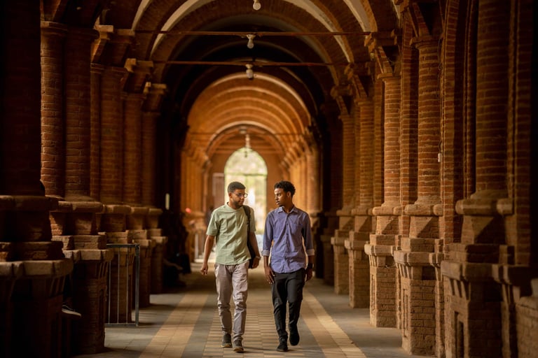 Students walking in old Sudanese campus hallway