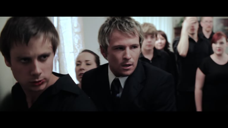 A group of young people all dressed in black attending a wake