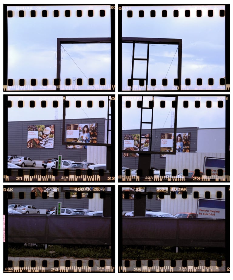 Composed image of a street scene with parked cars and commercial buildings, film strip 