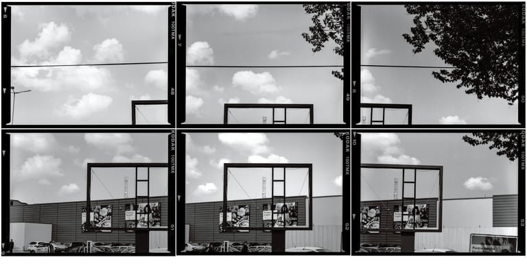 Composed photo featuring a spacious vacant outdoor billboard within an commercial urban environment