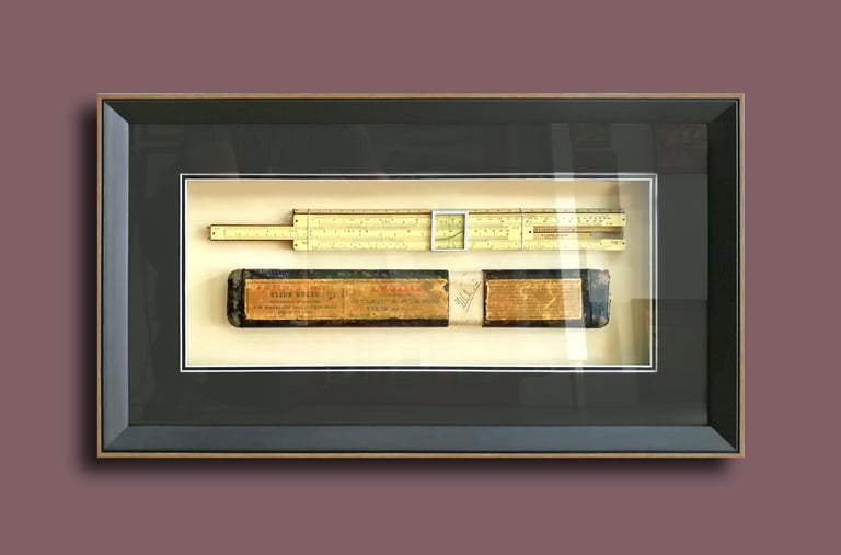 Preserve history elegantly with an old ivory slide ruler encased in a sophisticated black frame.