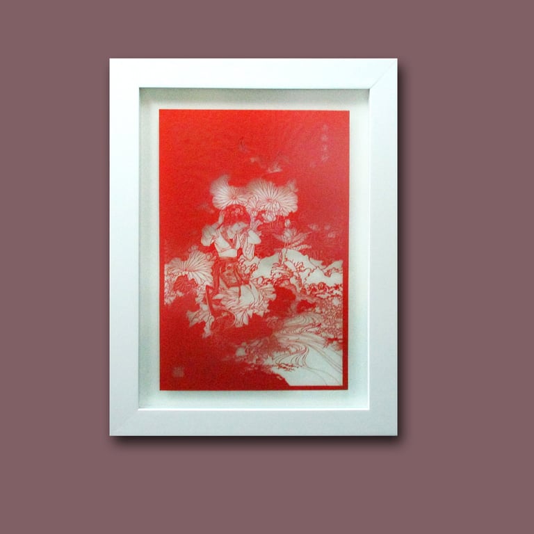 The white frame accentuates the intricate intricacies of this paper art, drawing focus to its delicate craftsmanship.