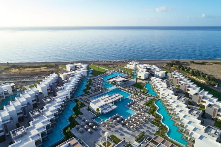 Aerial view of a luxury beachfront resort with private swimming pools and modern architecture.