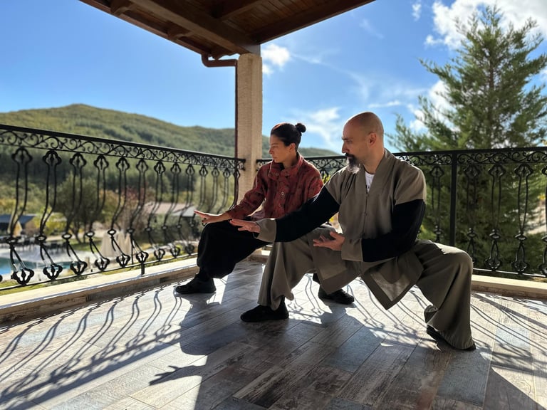 Ismet Himmet and Tuğba Türel practicing Tai Ji on a balcony during Bi Gu light fasting retreat.