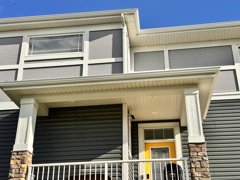 Repairing damaged gutters and downspouts on a Calgary home, Everdrains professional repair service