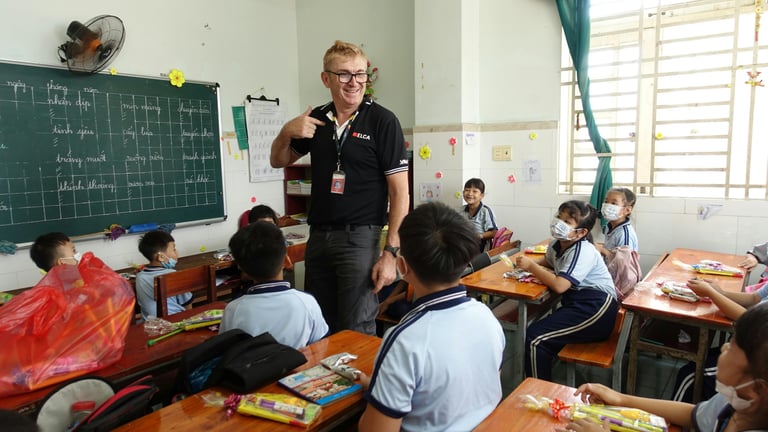 English teacher standing at the front of a classroom in Cambodia