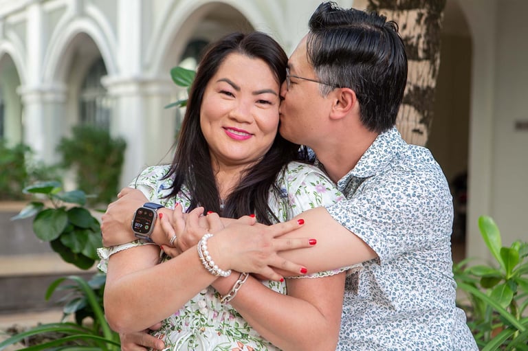 Couple hugging with a kiss outside Marina Phu Quoc arched building
