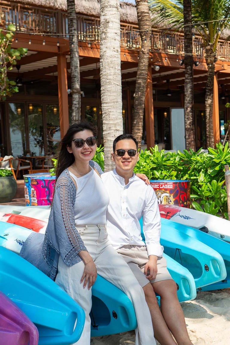 Couple posing on kayaks at Khem Beach near New World