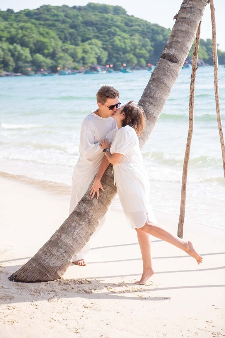 Couple kissing by palm tree near InterContinental Long Beach