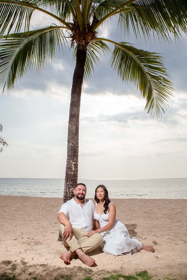 Couple sitting under palm tree on Long Beach Phu Quoc