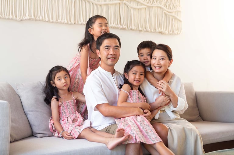Cozy family portrait with three kids in bright villa