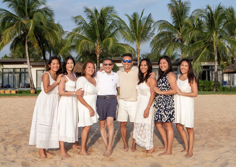 Multigenerational family beach photoshoot with palm trees