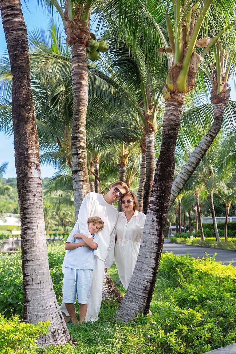 Family portrait under coconut palms at Radisson Blu resort