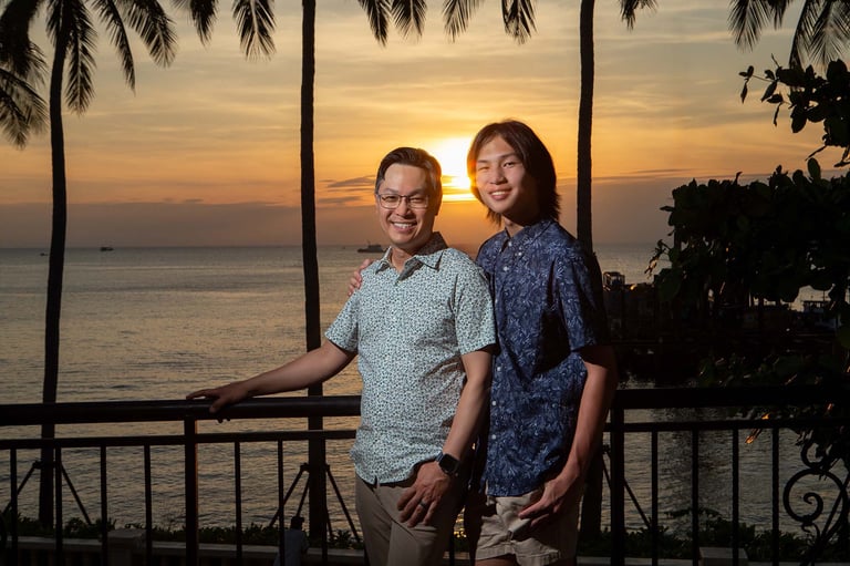 Father and son sunset portrait on tropical balcony