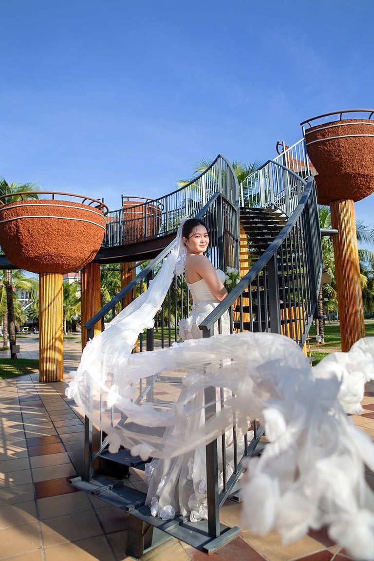 Bride with long veil on Grand World stairs