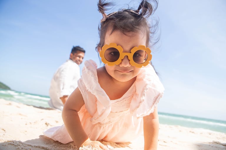 Toddler in flower sunglasses on Marriott beach family photoshoot
