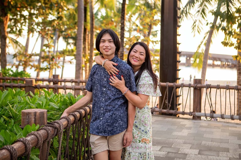 Mother hugs teenage son at Sunset Town waterfront