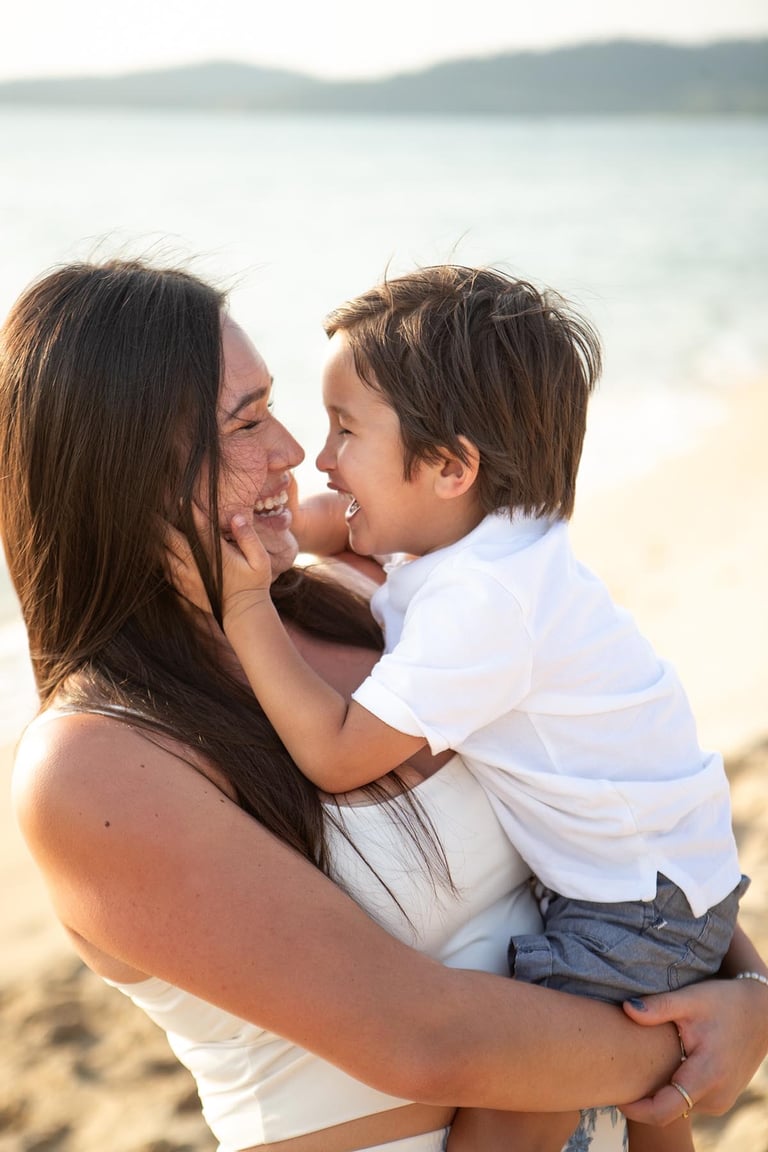 Mother and toddler laughing on Bai Sao Beach