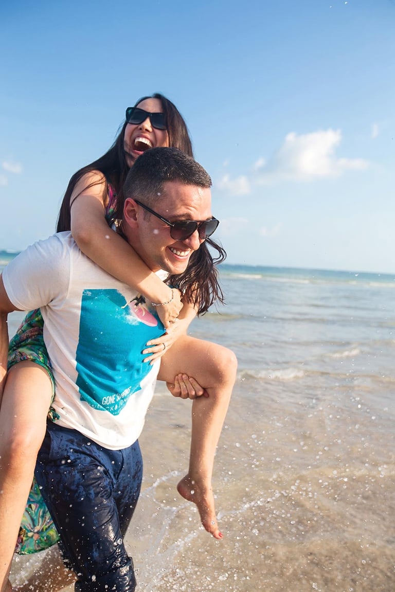 Playful couple splash photo at Sunset Town beach Phu Quoc