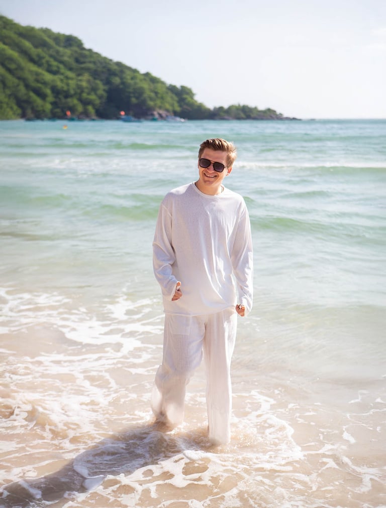 Solo traveler walking in waves near Pullman Phu Quoc Resort