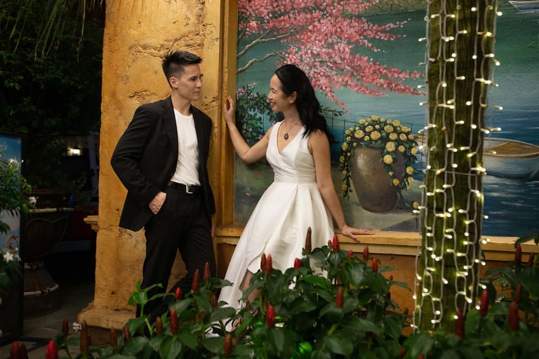 Wedding couple posing by mural lights in Sunset Town