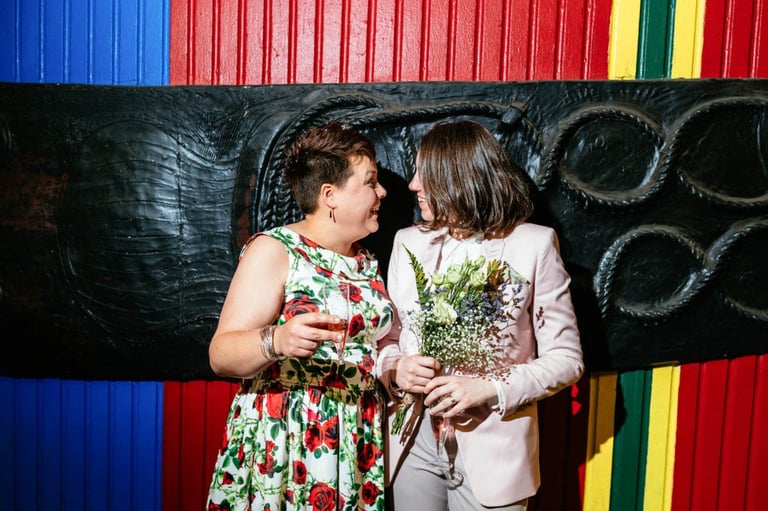 Two brides share a joyful moment at their Cardiff LGBTQ+ wedding