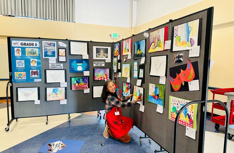 a docent setting up an art show display