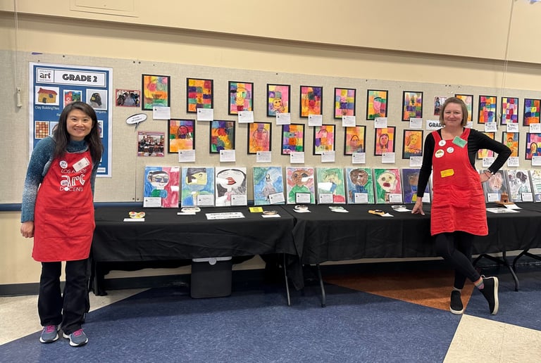 2 docents setting up an art show exhibit