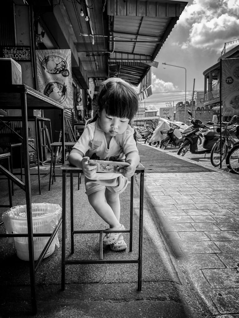 Indonesian girl playing on a mobile phone