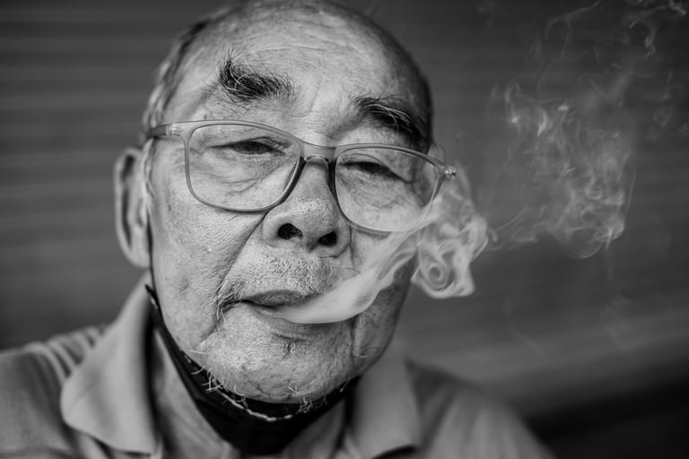 Portrait of a Thai man smoking tobacco