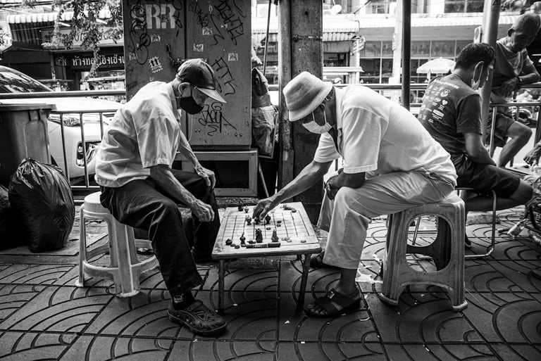 Thai gentlemen playing chess on the street
